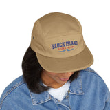 BlockBoundRI tan 5-panel cotton cap with Block Island Rhode Island wave embroidery worn by a person in a denim jacket